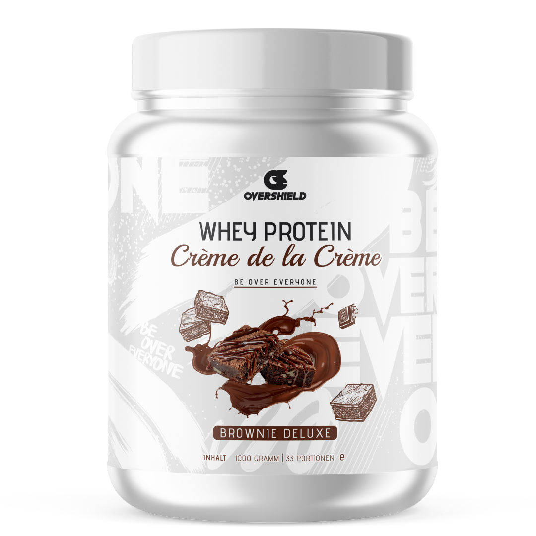 Brownie Deluxe Whey Protein in einer weißer Dose mit dem Schriftzug Crème de la Créme. Der Inhalt entspricht 33 Portionen.